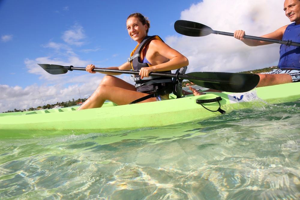 Couple canoeing in lagoon of West French indies